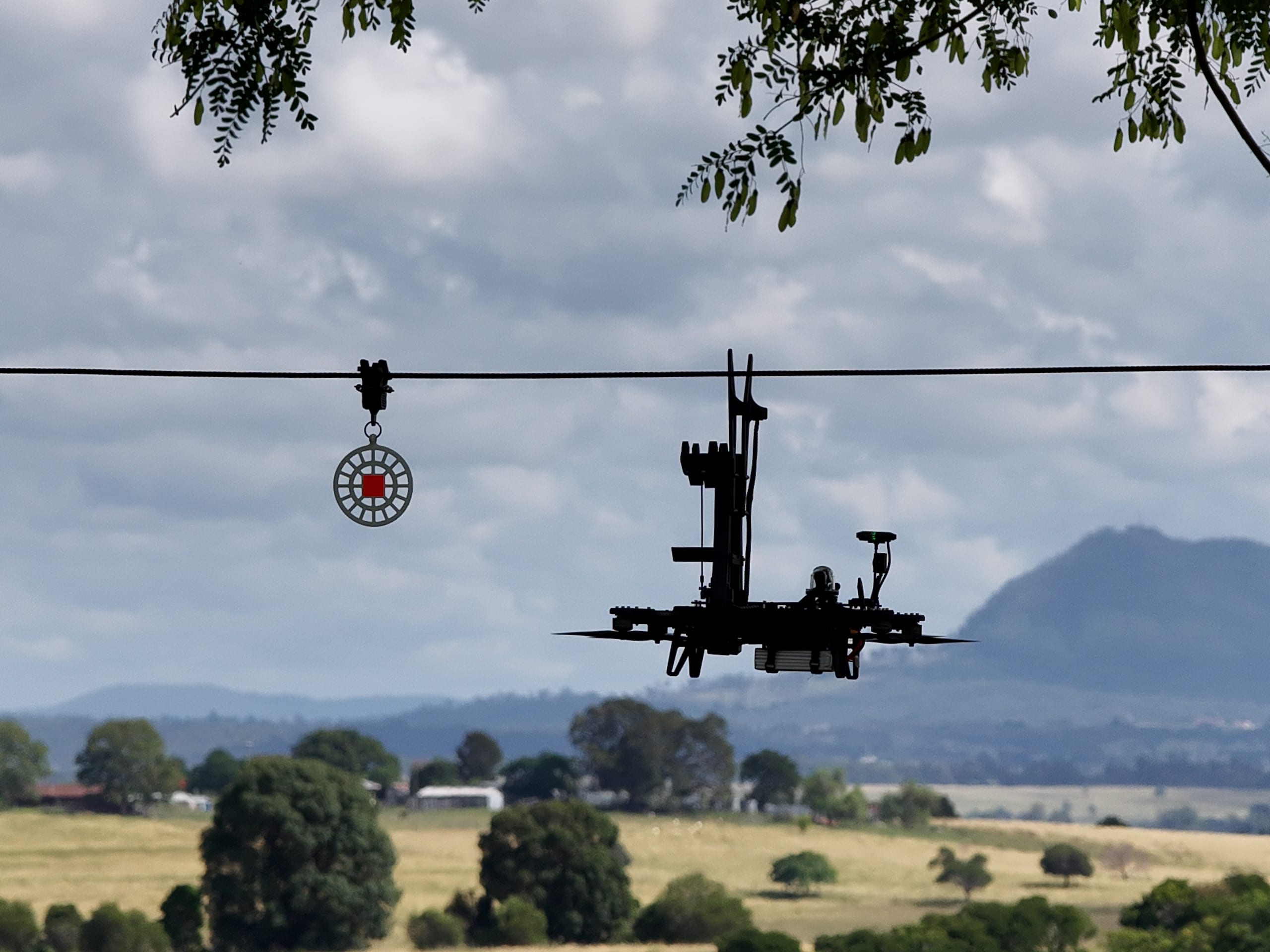 AeroClip drone installing a bird diverter on an overhead powerline